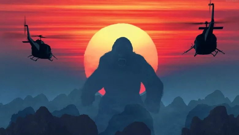 Kong looms over a burning landscape, helicopters in the sky