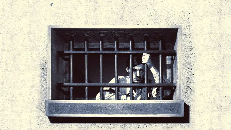 Movie still from A Man Escaped, showing a hand carefully manipulating a piece of wood.