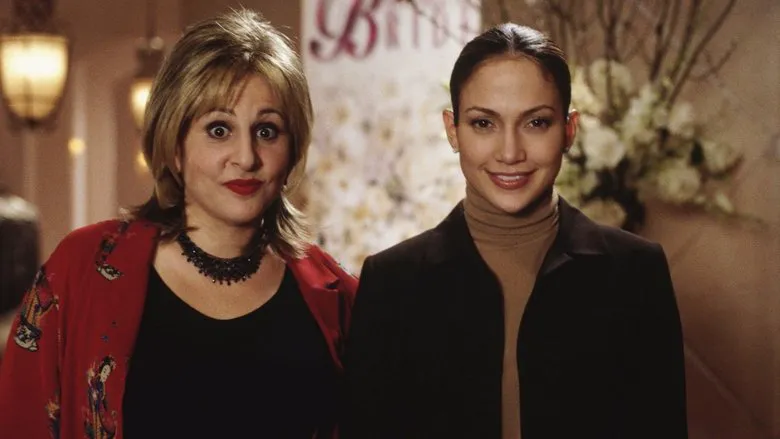 Jennifer Lopez in an elegant dark dress, exuding sophistication and style at an indoor event.