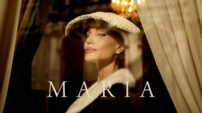 Angelina Jolie in a powerful and dramatic pose as Maria Callas, bathed in blue light.