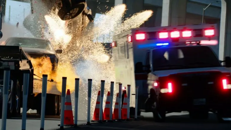 A public scene showing an ambulance and emergency responders