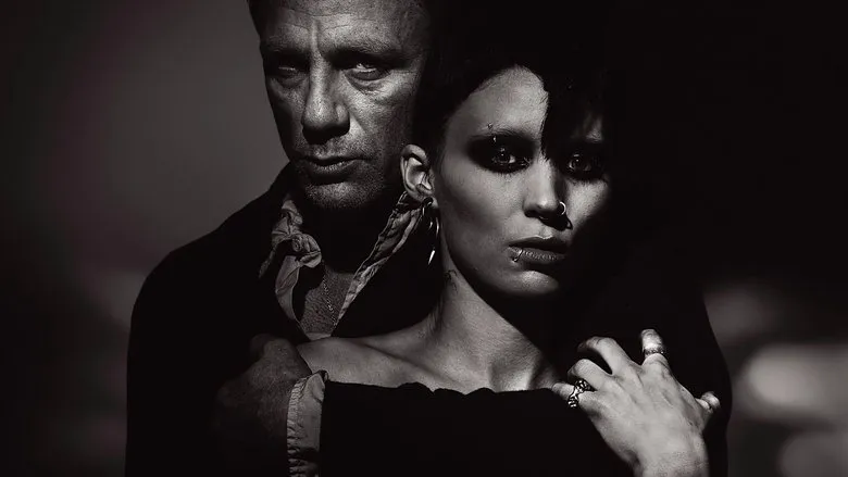 Mikael Blomkvist intensely discusses with Lisbeth Salander in a dimly lit setting.
